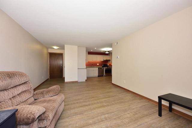 living room featuring baseboards and light wood finished floors