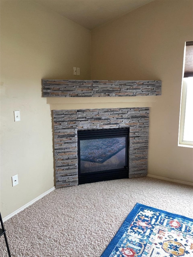 details featuring baseboards, a fireplace, and carpet flooring