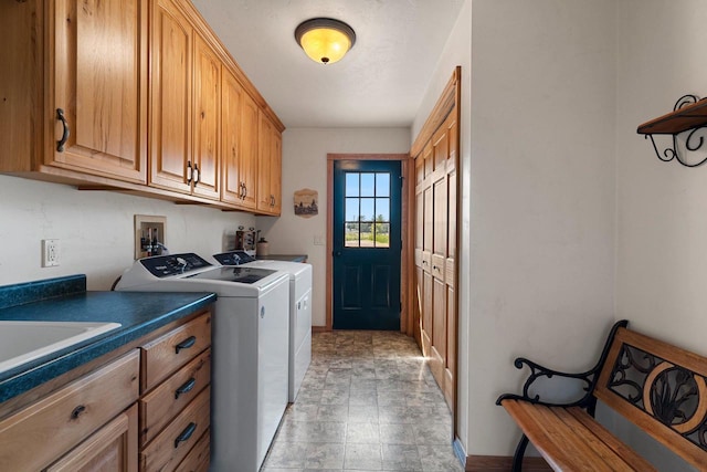 laundry room featuring a sink, cabinet space, and washer and dryer
