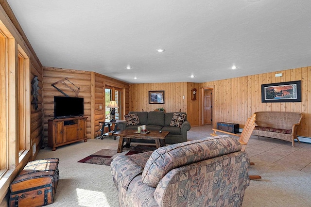 carpeted living room featuring rustic walls, recessed lighting, and a textured ceiling