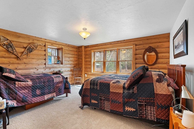 bedroom featuring carpet floors, a textured ceiling, and log walls