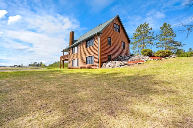 view of property exterior featuring faux log siding, a yard, and a chimney