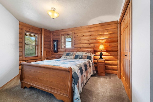 bedroom featuring rustic walls, light carpet, and baseboards