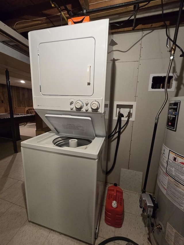 laundry area with stacked washing maching and dryer and water heater