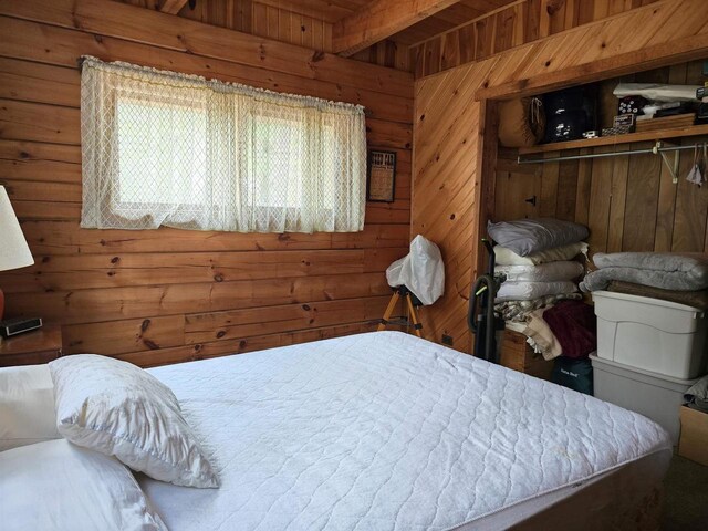 bedroom featuring wood walls