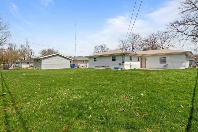 rear view of property with a yard