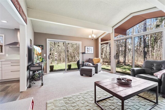1206 Pinecrest Ln, New Richmond, WI 54017 - living room with a textured ceiling, a chandelier, and light carpet