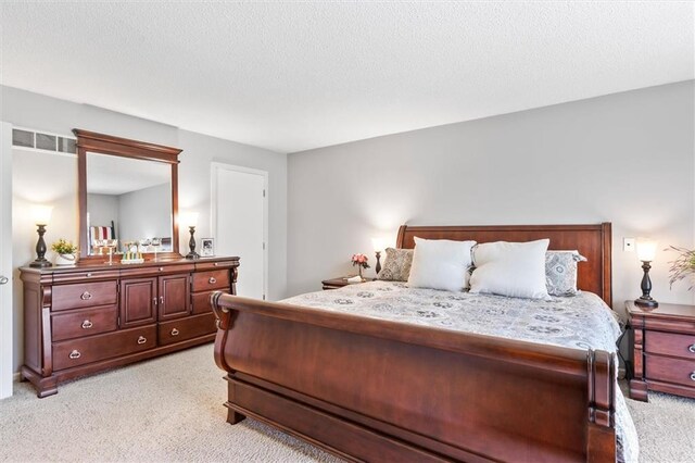 1206 Pinecrest Ln, New Richmond, WI 54017 - bedroom with a textured ceiling and light carpet