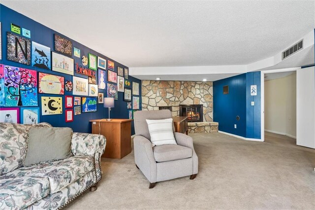 1206 Pinecrest Ln, New Richmond, WI 54017 - living area featuring carpet flooring, a fireplace, a textured ceiling, an accent wall, and visible vents