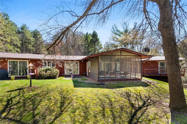 1206 Pinecrest Ln, New Richmond, WI 54017 - view of front of house featuring a sunroom, a deck, and a front yard