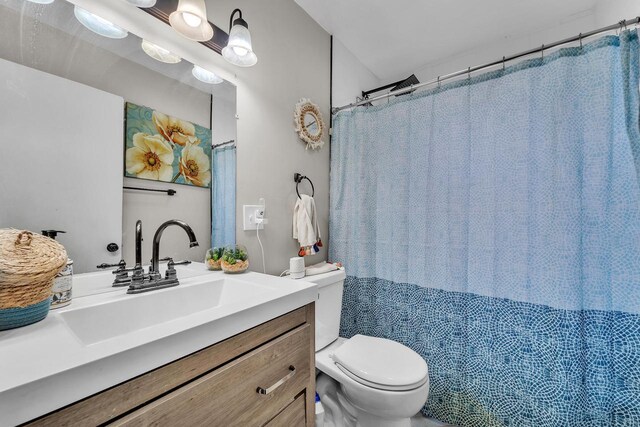 full bathroom with toilet and vanity