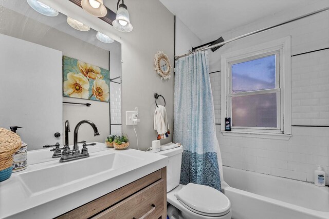 bathroom with vanity, shower / bath combo with shower curtain, and toilet