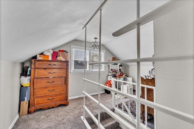 additional living space featuring carpet floors, baseboards, and lofted ceiling