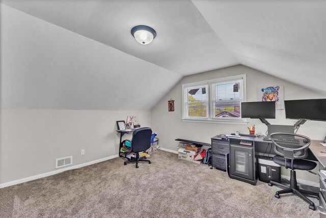 home office featuring visible vents, baseboards, carpet floors, and lofted ceiling