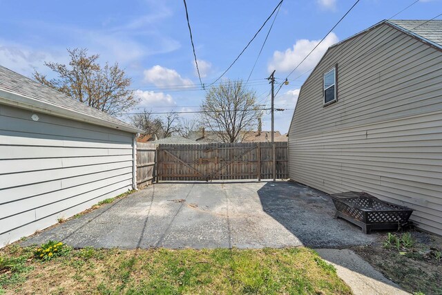 view of patio featuring fence and a gate