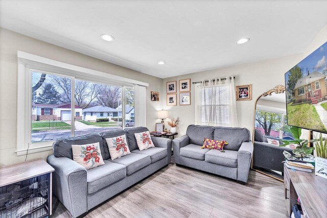 living room with recessed lighting and wood finished floors