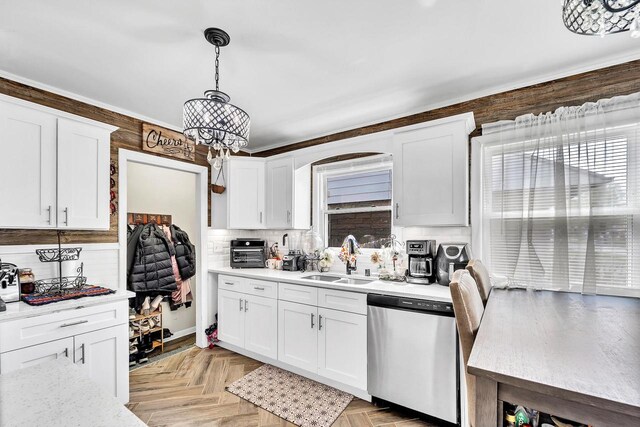 kitchen featuring decorative backsplash, stainless steel dishwasher, a sink, light countertops, and white cabinets
