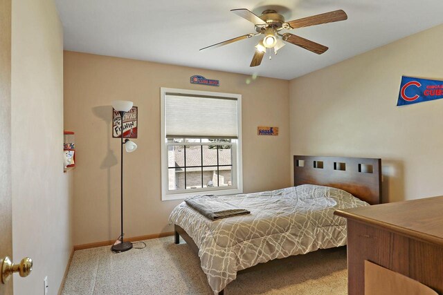 bedroom with carpet floors, a ceiling fan, and baseboards