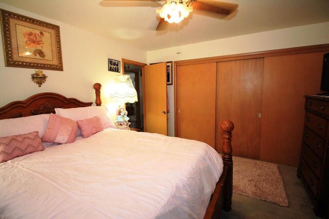 carpeted bedroom featuring a closet and a ceiling fan