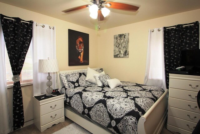 bedroom featuring a ceiling fan and light carpet