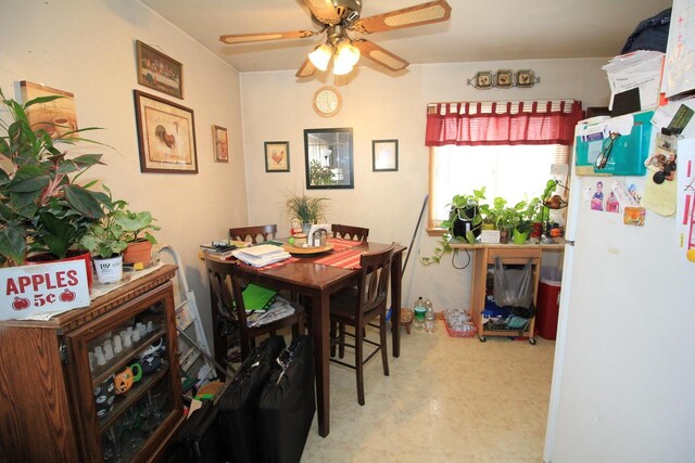 dining space with tile patterned floors and ceiling fan