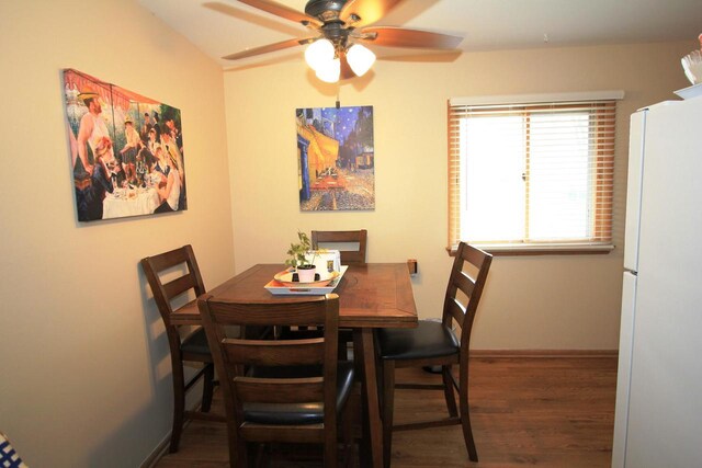 dining space with baseboards, ceiling fan, and wood finished floors