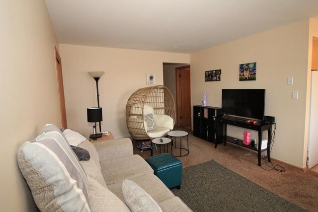 carpeted living room featuring baseboards