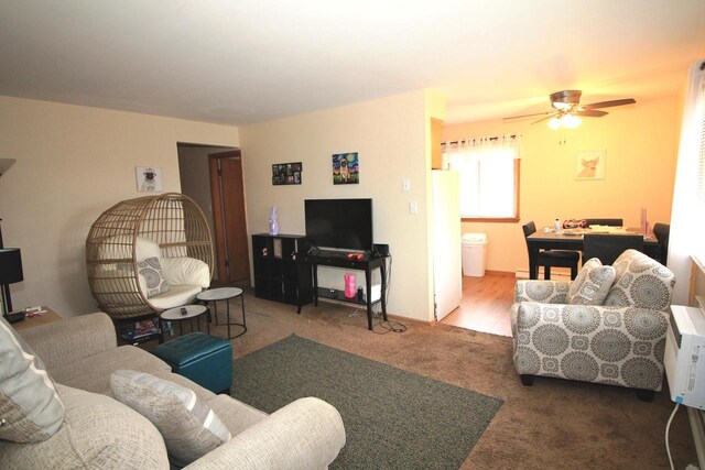 living area with carpet flooring and ceiling fan