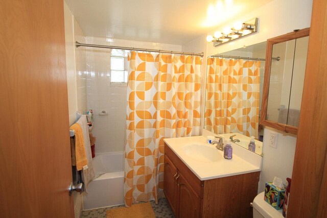 full bath with vanity, shower / bath combo, and toilet