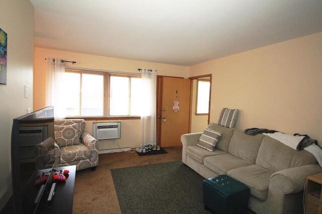 carpeted living area with baseboard heating and a wall unit AC