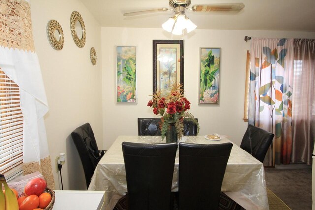 dining space with carpet flooring and a ceiling fan