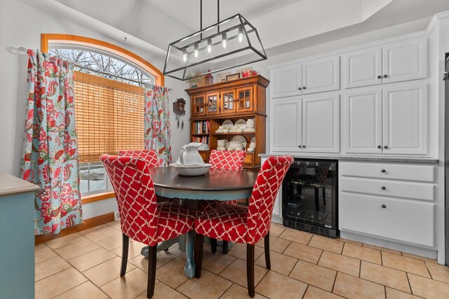 dining space featuring beverage cooler and light tile patterned flooring