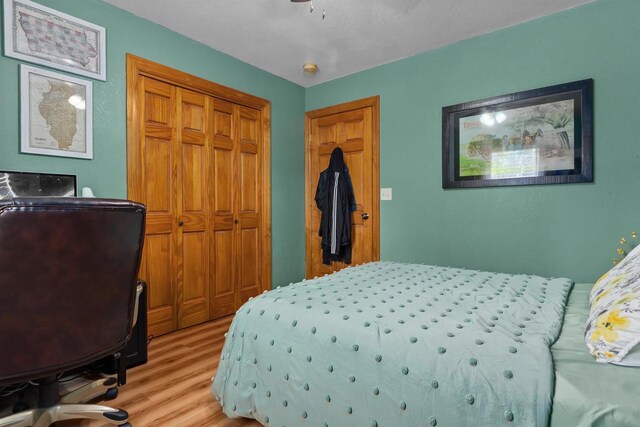 bedroom with a closet and light wood-style flooring