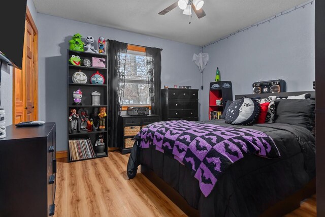 bedroom featuring a ceiling fan and light wood finished floors