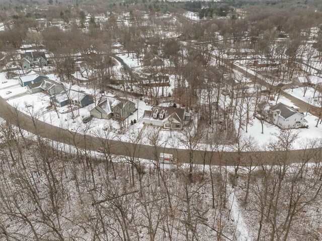 snowy aerial view with a residential view