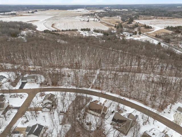 snowy aerial view with a residential view