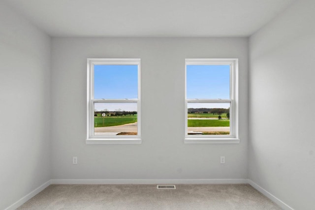 N6285 Blarney Stone Dr, Albany, WI 53520 - carpeted empty room featuring baseboards, visible vents, and plenty of natural light
