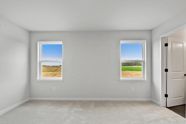 N6285 Blarney Stone Dr, Albany, WI 53520 - unfurnished room featuring baseboards, carpet flooring, and a healthy amount of sunlight
