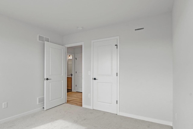 N6285 Blarney Stone Dr, Albany, WI 53520 - unfurnished bedroom featuring baseboards, visible vents, and carpet