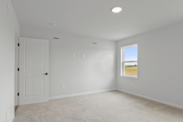 N6285 Blarney Stone Dr, Albany, WI 53520 - spare room featuring baseboards, light carpet, and visible vents