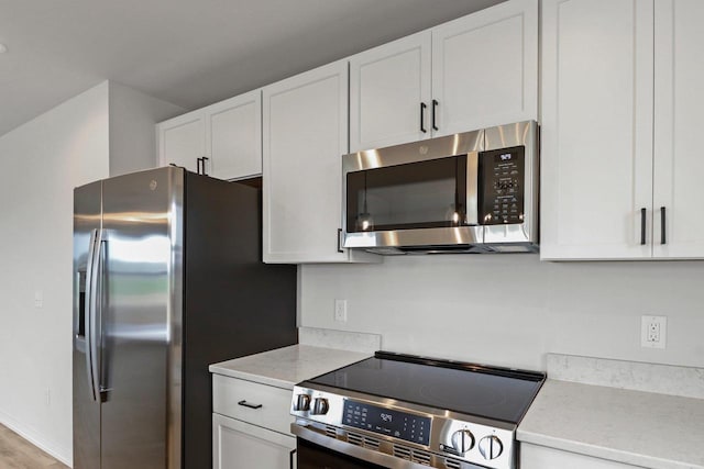 N6285 Blarney Stone Dr, Albany, WI 53520 - kitchen featuring light countertops, white cabinets, and stainless steel appliances