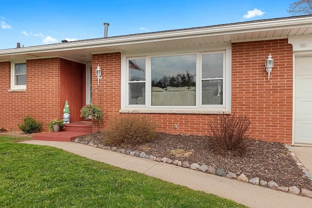 view of front of property with brick siding and a garage