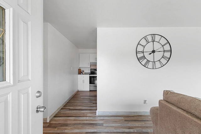 hall featuring baseboards and wood finished floors