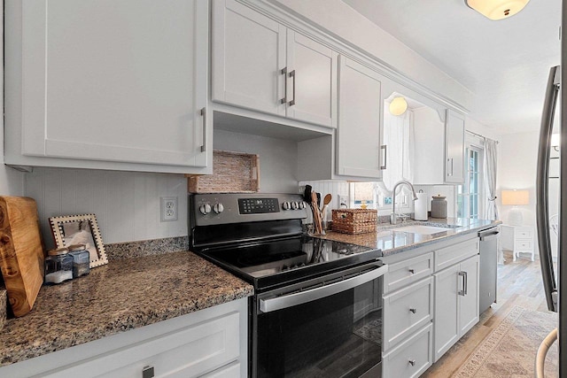 kitchen featuring a sink, white cabinetry, and stainless steel appliances
