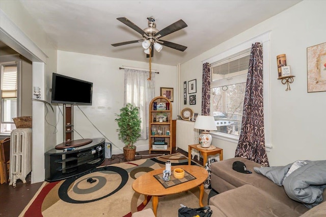 living room with a ceiling fan and radiator