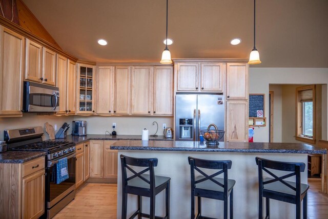 W5588 S Stone Gate Dr, New Lisbon, WI 53950 - kitchen with recessed lighting, light wood finished floors, stainless steel appliances, and a kitchen bar