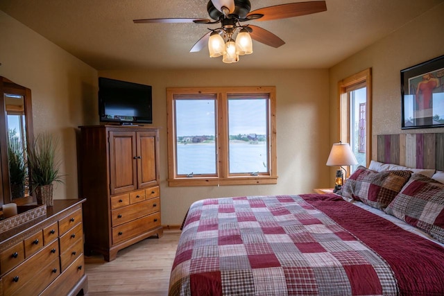 W5588 S Stone Gate Dr, New Lisbon, WI 53950 - bedroom with a ceiling fan and light wood-style flooring