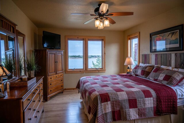 W5588 S Stone Gate Dr, New Lisbon, WI 53950 - bedroom featuring a ceiling fan and light wood-style flooring