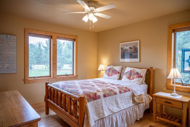 W5588 S Stone Gate Dr, New Lisbon, WI 53950 - bedroom featuring light wood finished floors and ceiling fan