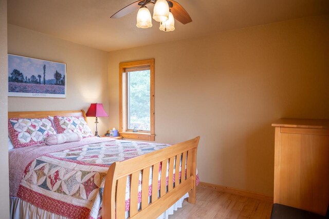 W5588 S Stone Gate Dr, New Lisbon, WI 53950 - bedroom featuring baseboards, a ceiling fan, and wood finished floors